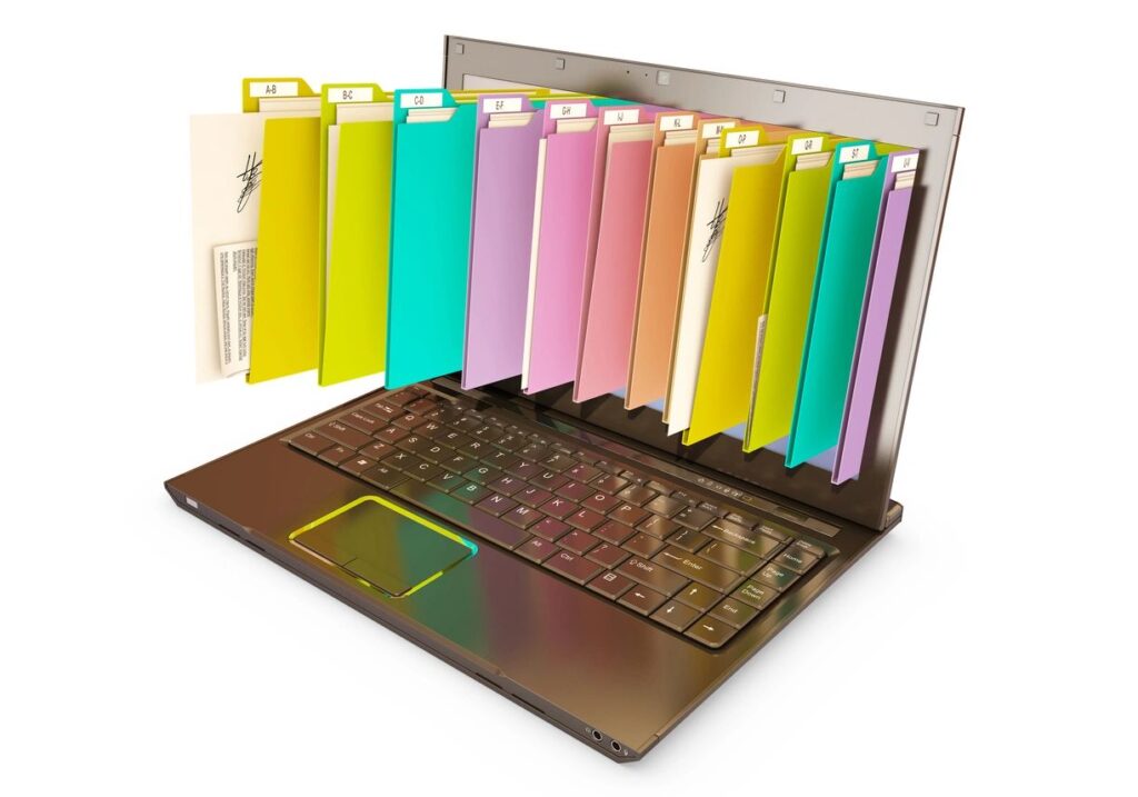 A laptop with several folders on the screen.