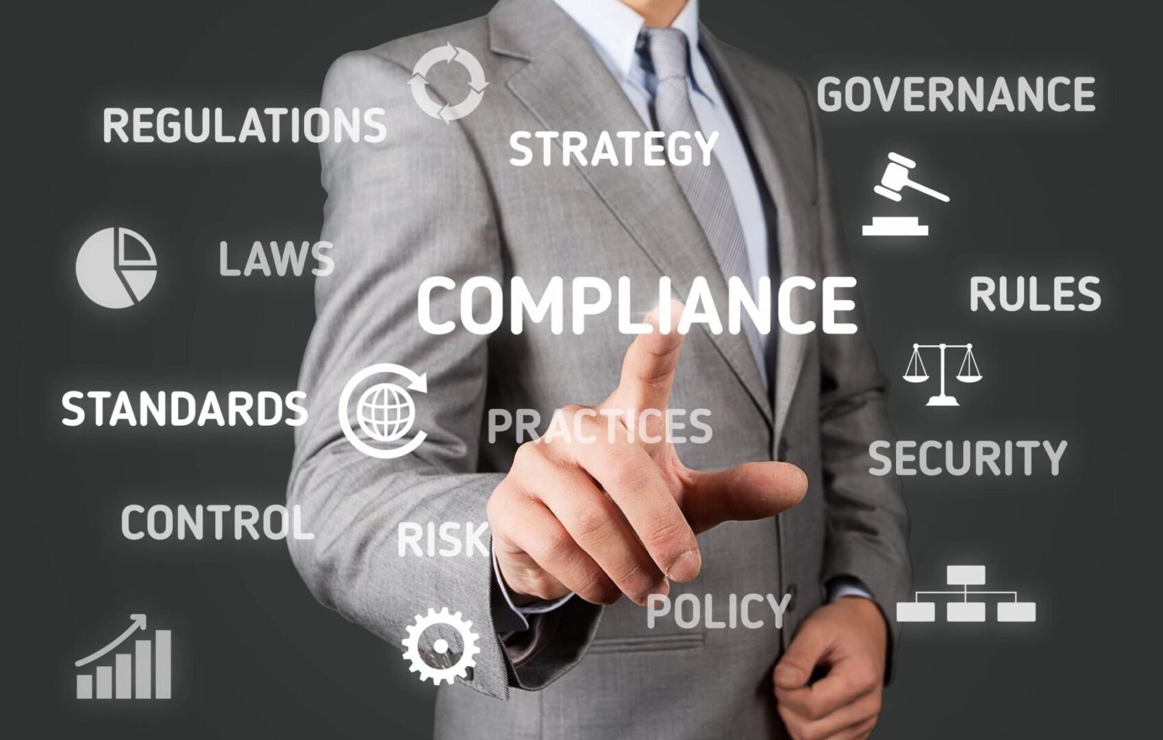 A man in a suit pointing to the word compliance.